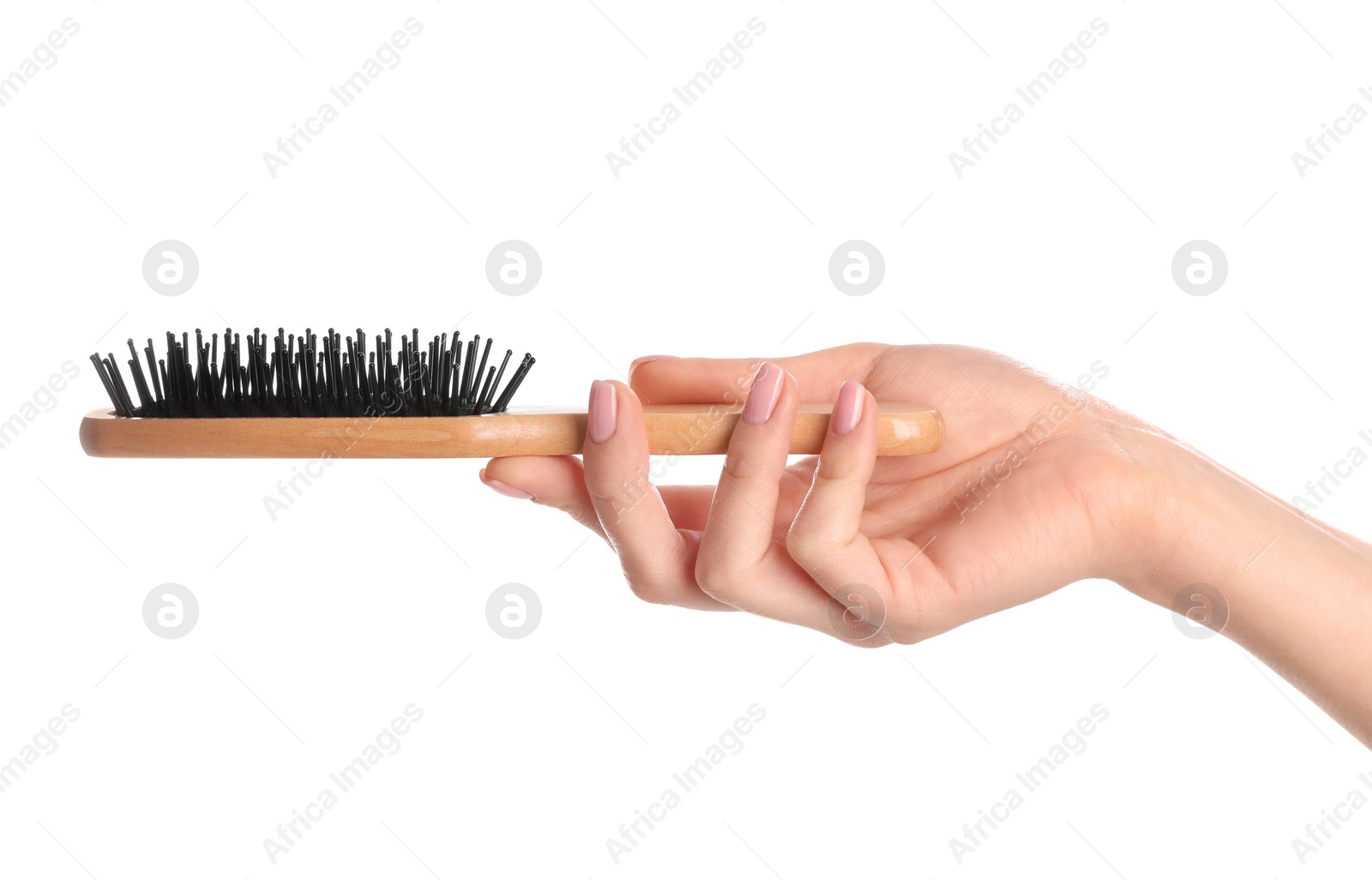 Photo of Woman holding wooden hair brush against white background, closeup