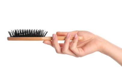 Photo of Woman holding wooden hair brush against white background, closeup