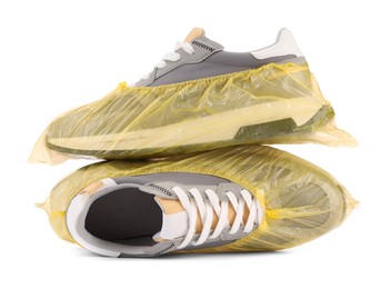 Photo of Men's sneakers in yellow shoe covers isolated on white