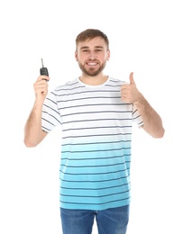 Happy young man with car key on white background. Getting driving license