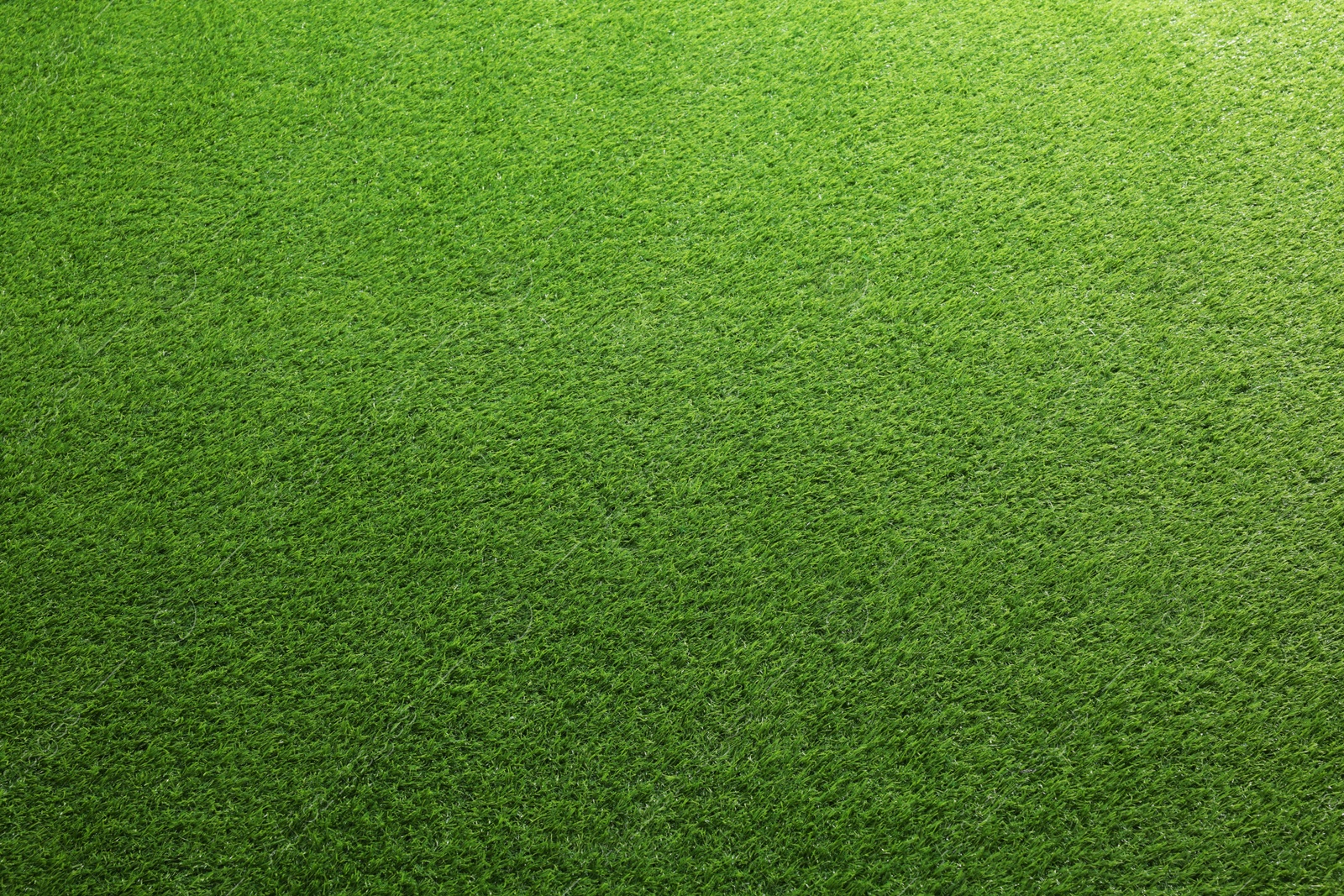 Photo of Green artificial grass as background, top view