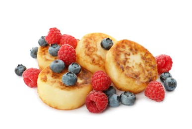 Delicious cottage cheese pancakes with fresh berries on white background