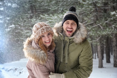Photo of Portrait of happy couple in forest on snow day
