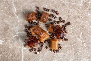 Ice cubes and coffee beans on grey background, flat lay