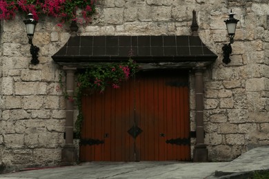 Brick building with beautiful wooden gates outdoors