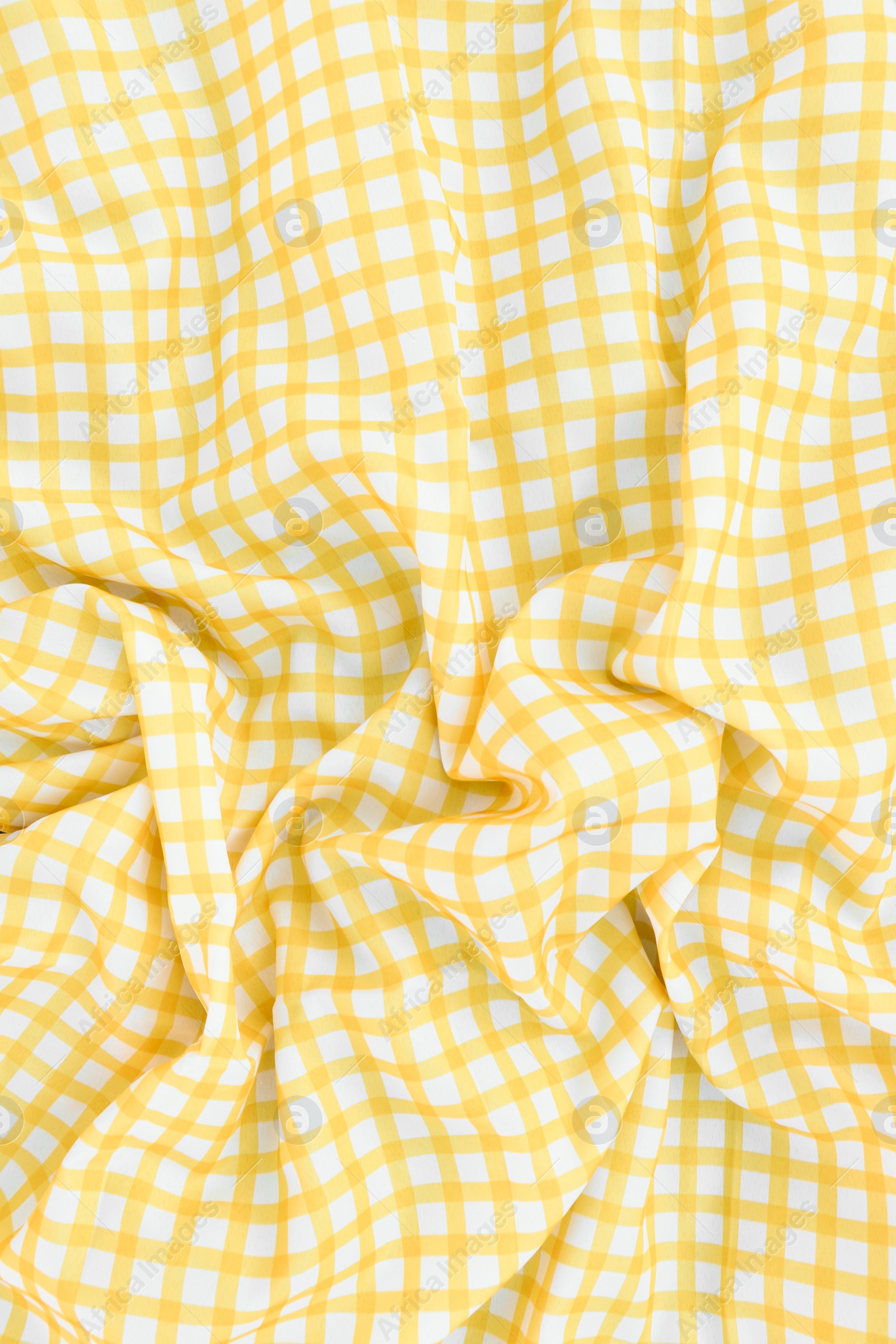 Photo of Yellow checkered picnic tablecloth as background, top view