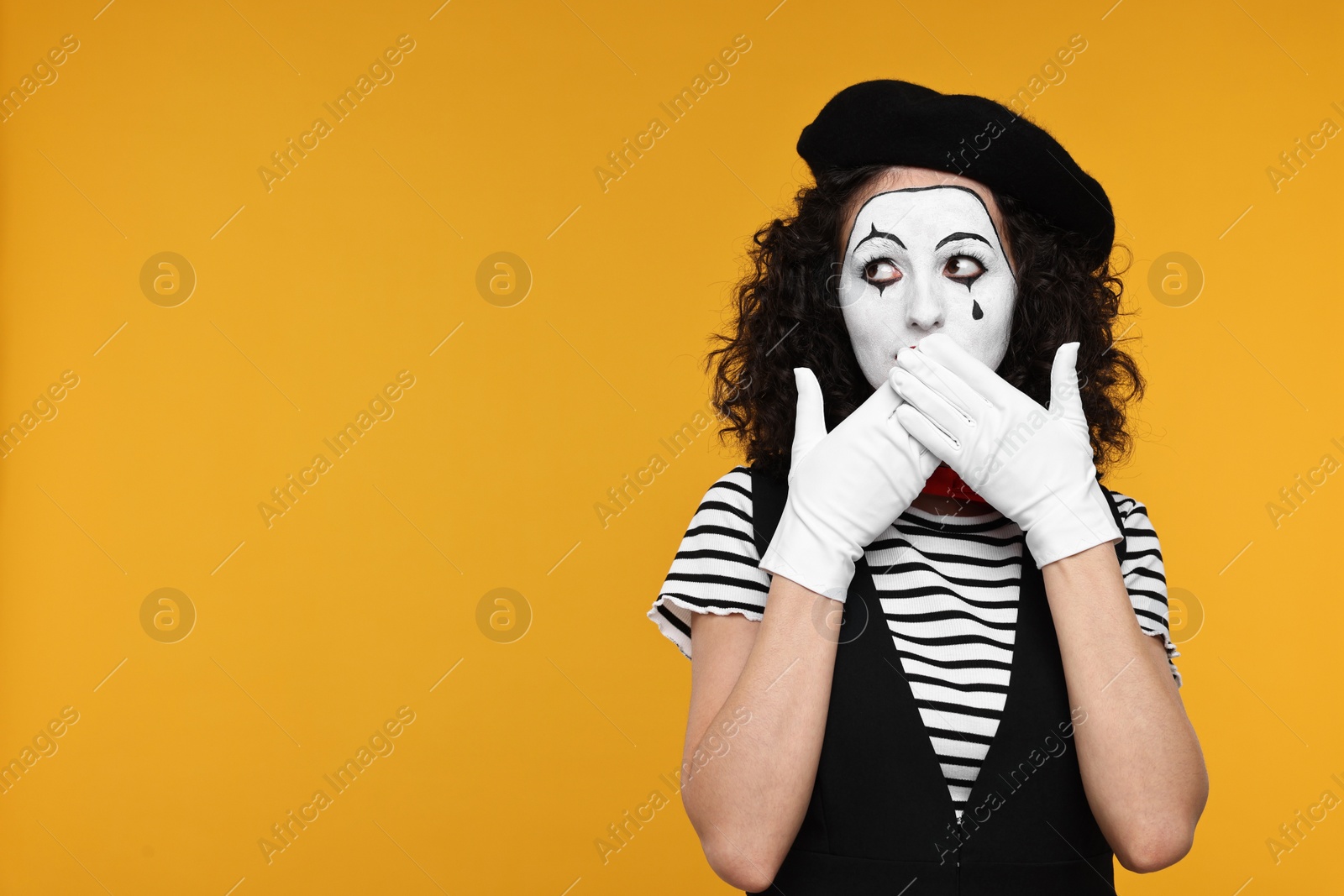 Photo of Funny mine with beret posing on orange background, space for text