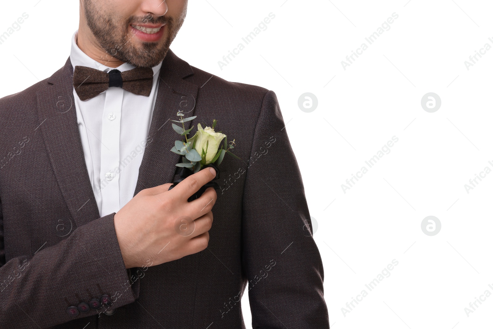 Photo of Groom with boutonniere on white background, closeup. Wedding accessory