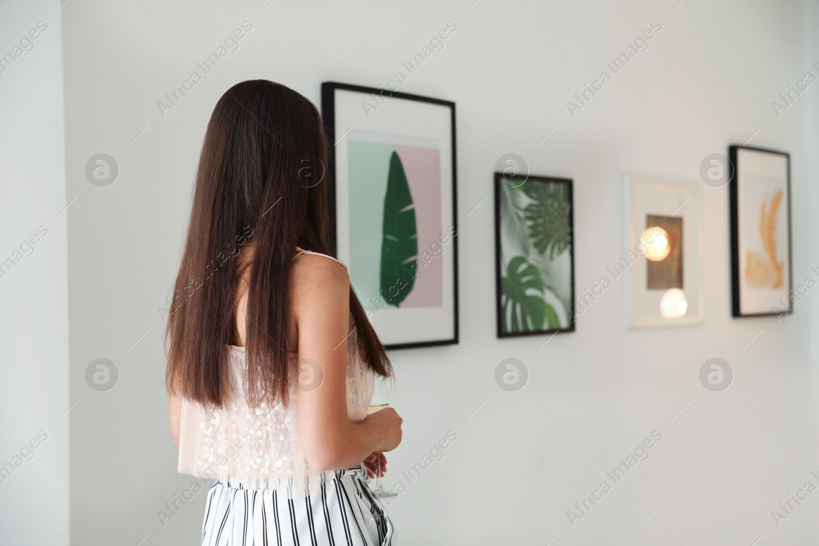 Photo of Young woman at exhibition in art gallery