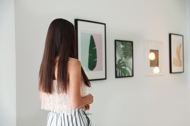 Young woman at exhibition in art gallery