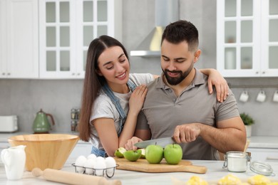 Photo of Happy young couple spending time together in kitchen