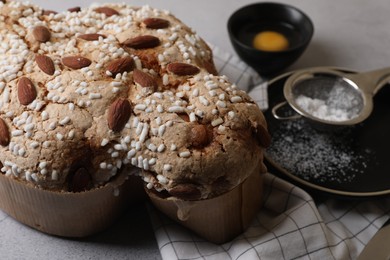 Delicious Italian Easter dove cake (Colomba di Pasqua) on grey table, closeup