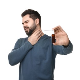 Photo of Young man holding throat spray on white background