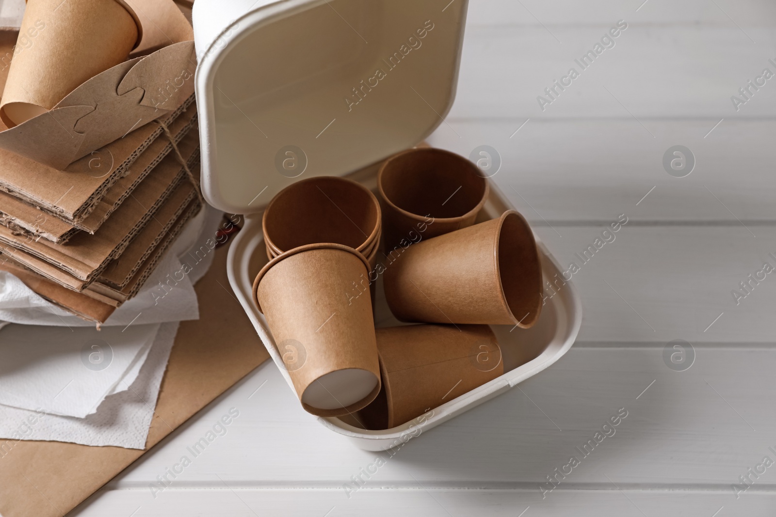 Photo of Heap of waste paper on white wooden table