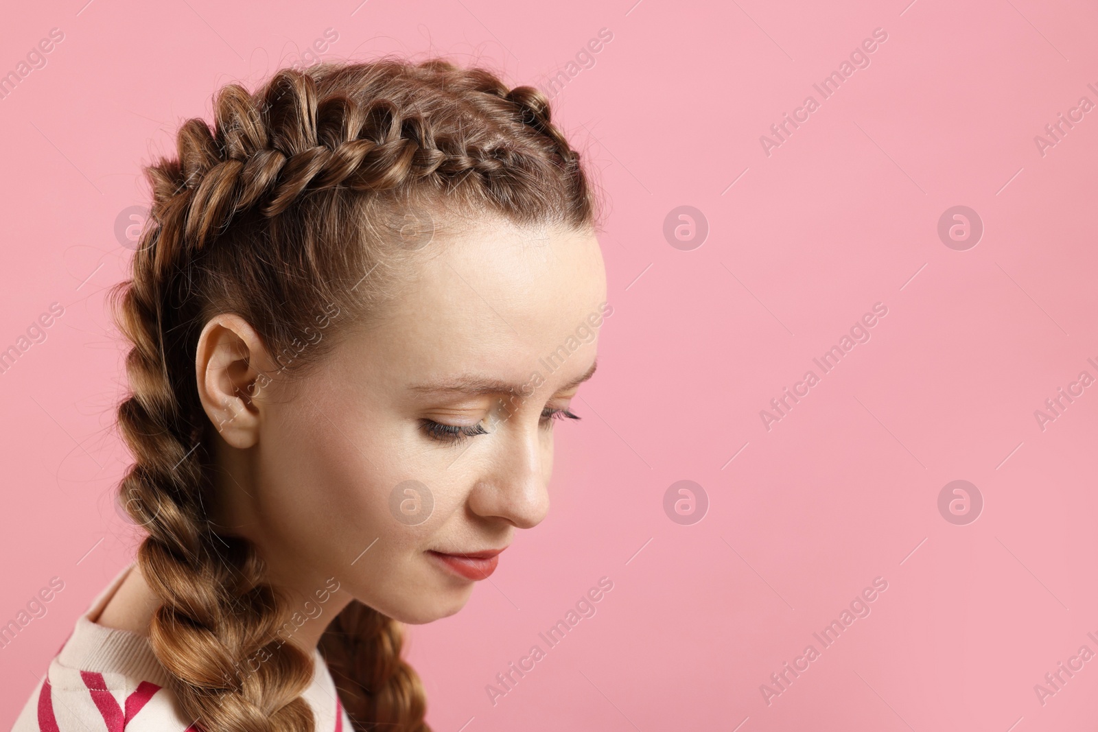 Photo of Woman with braided hair on pink background, space for text