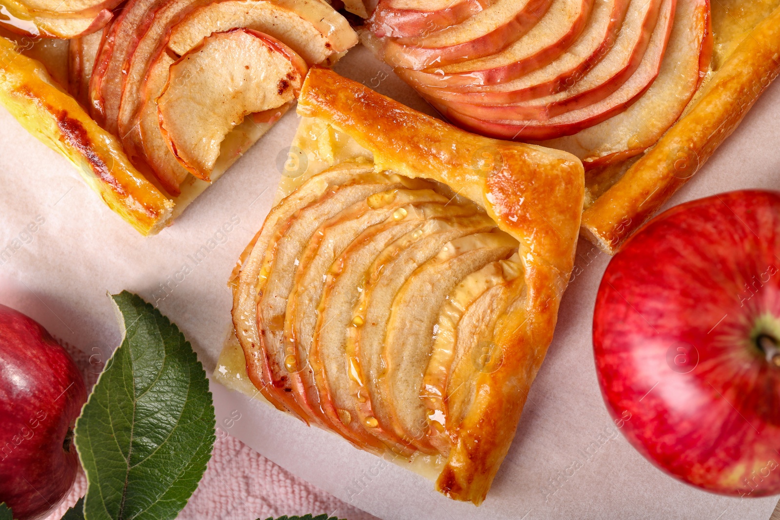 Photo of Piece of tasty apple pie and fresh fruits on table, flat lay