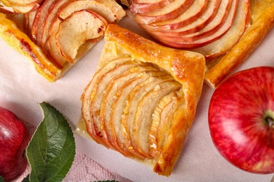 Photo of Piece of tasty apple pie and fresh fruits on table, flat lay