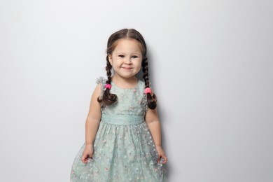 Photo of Cute little girl on light grey background