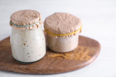 Photo of Sourdough starter in glass jars on light table