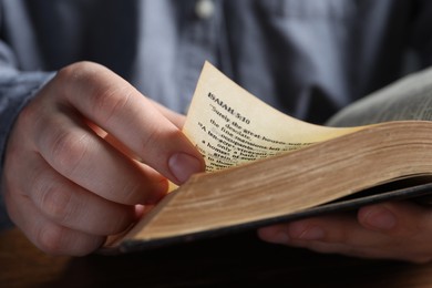 Photo of Man reading old holy Bible, closeup view