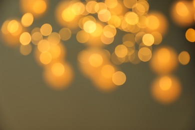 Blurred view of gold lights on dark background. Bokeh effect