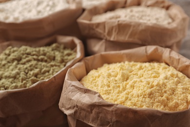 Photo of Paper bags with different types of flour, closeup