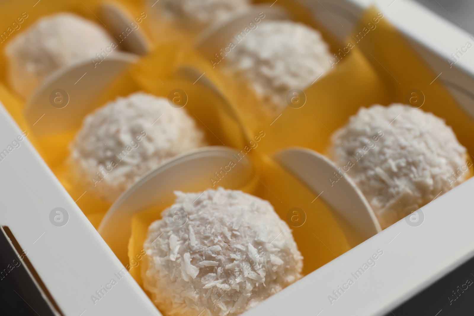 Photo of Delicious candies in white box, closeup view