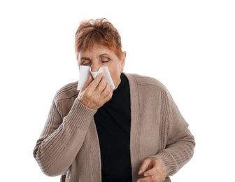 Elderly woman blowing nose on white background