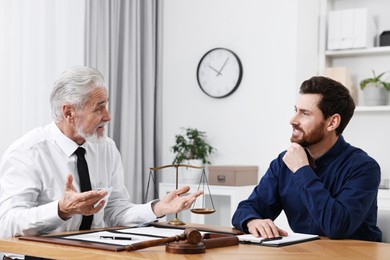 Photo of Man having meeting with lawyer in office