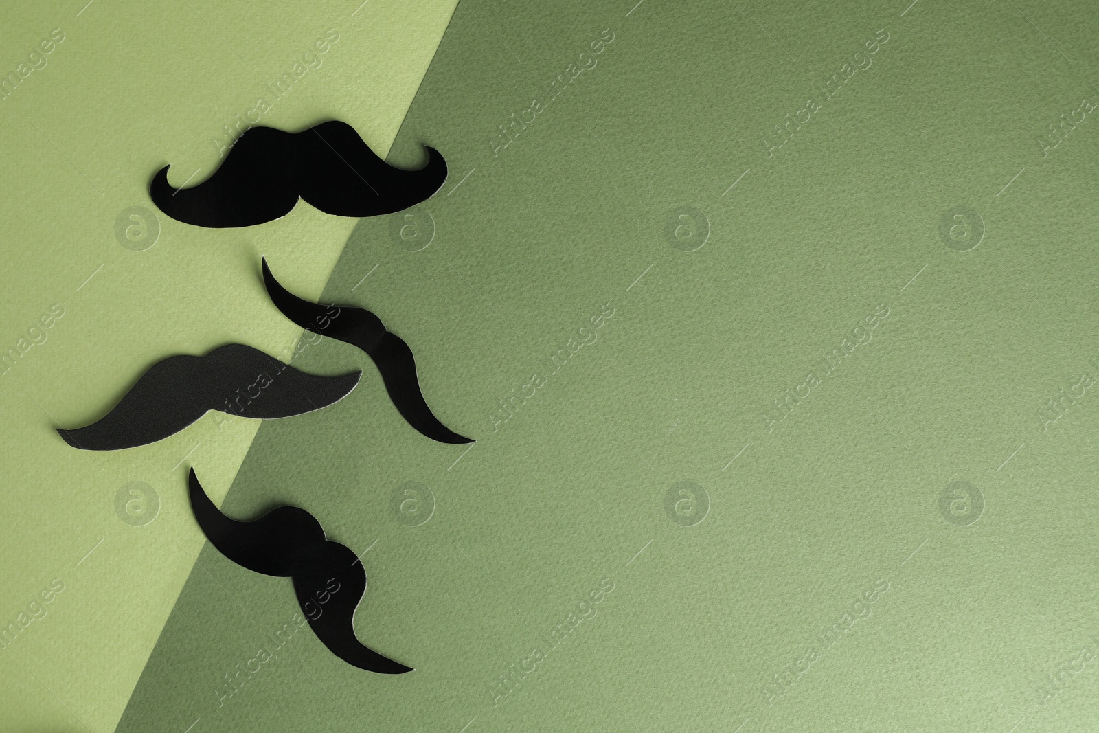 Photo of Fake paper mustaches on color background, flat lay. Space for text