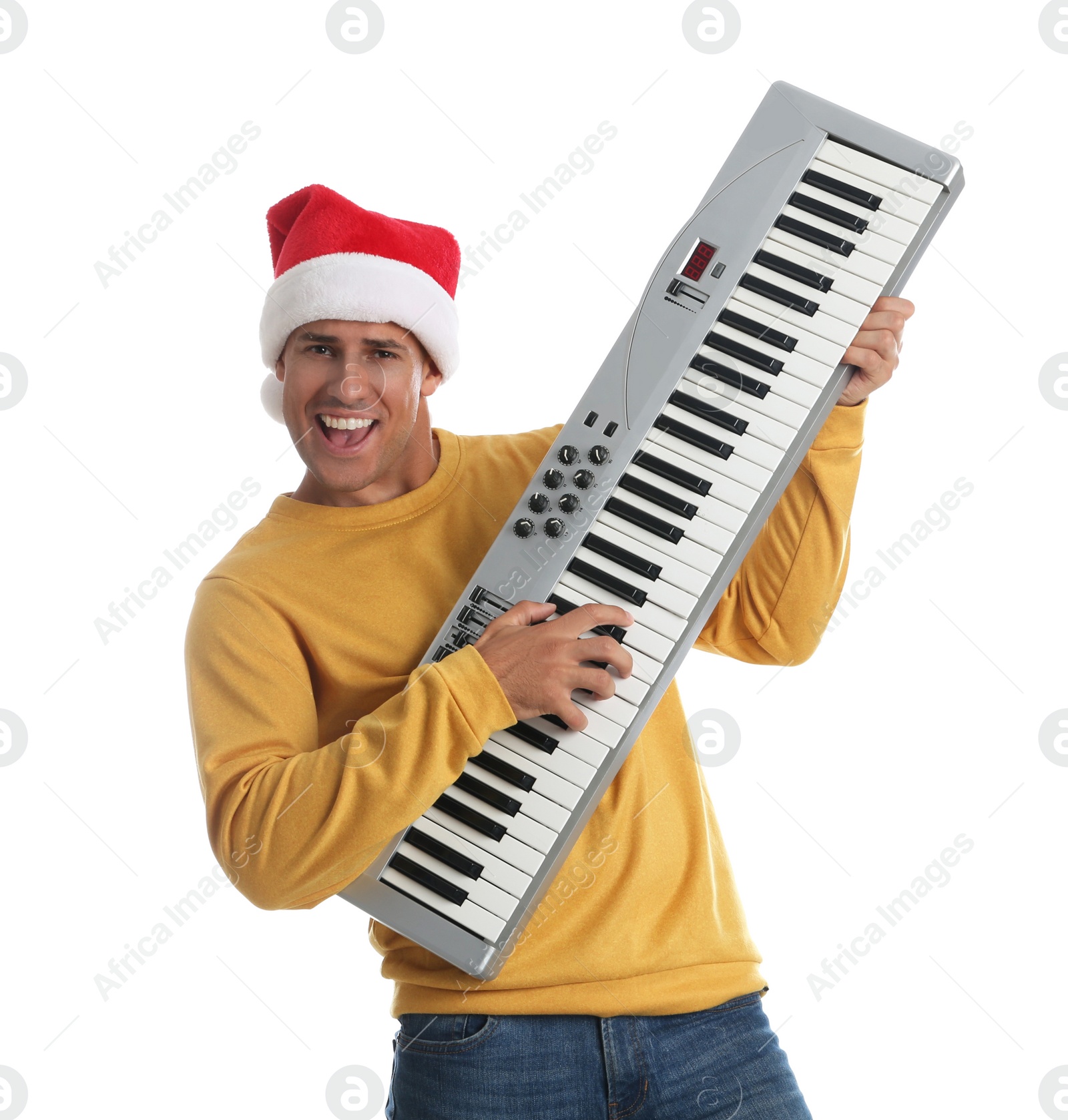 Photo of Man in Santa hat playing synthesizer on white background. Christmas music