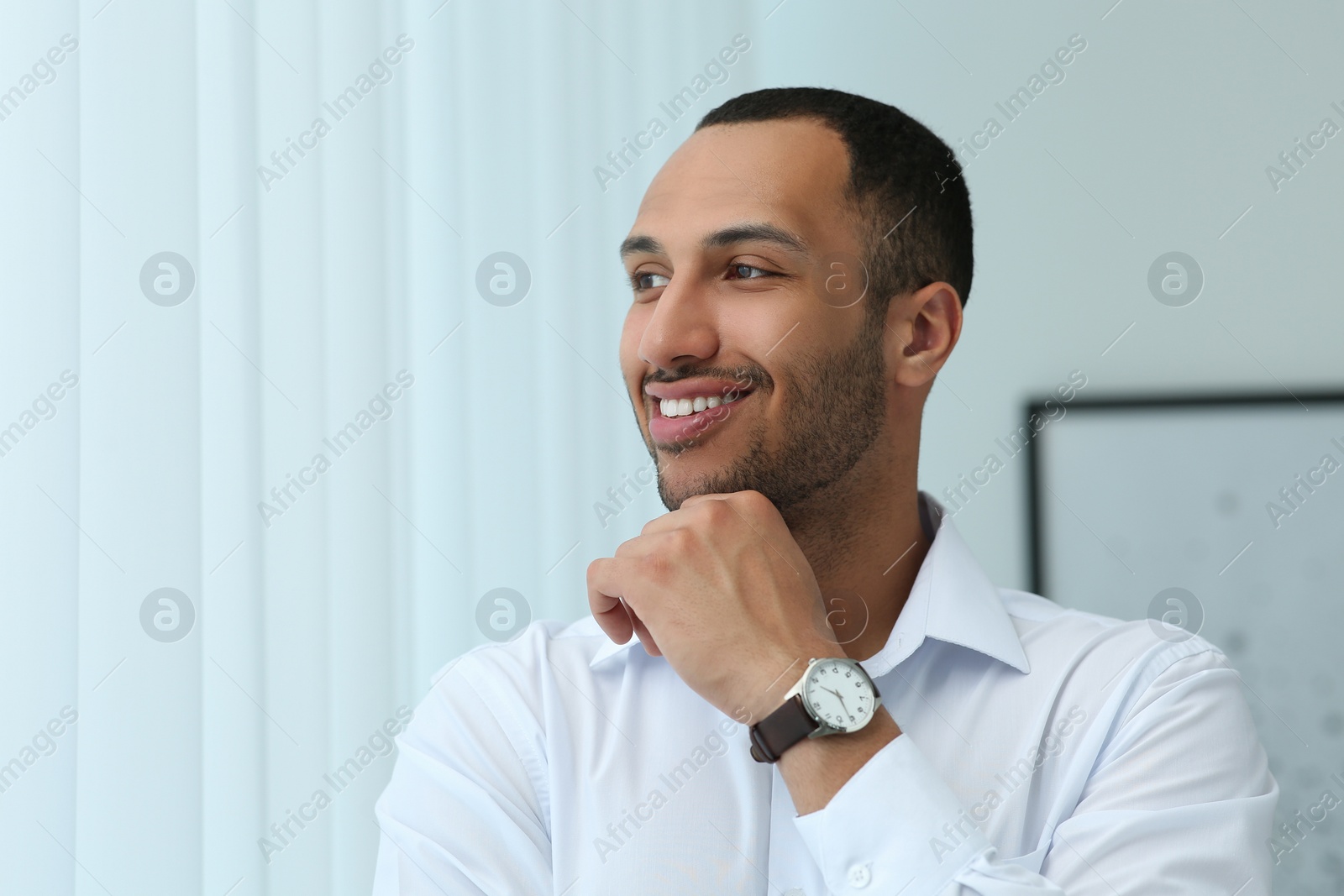 Photo of Portrait of handsome young man in white shirt indoors