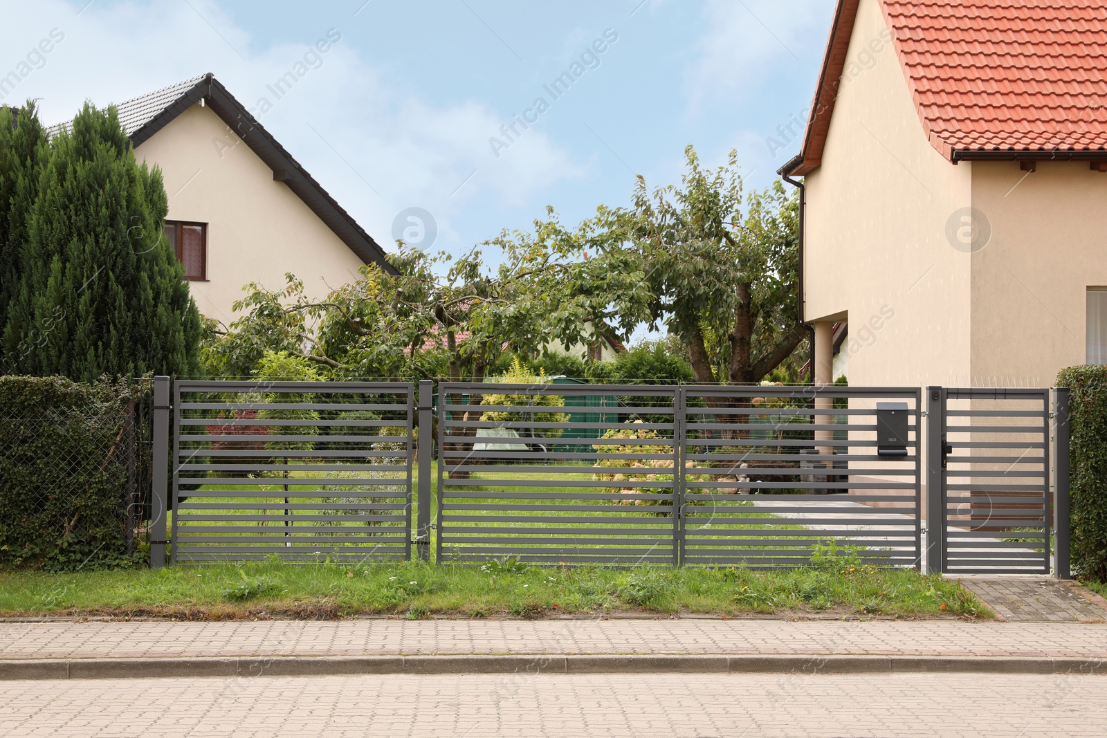 Photo of Grey metal gates near private houses on street