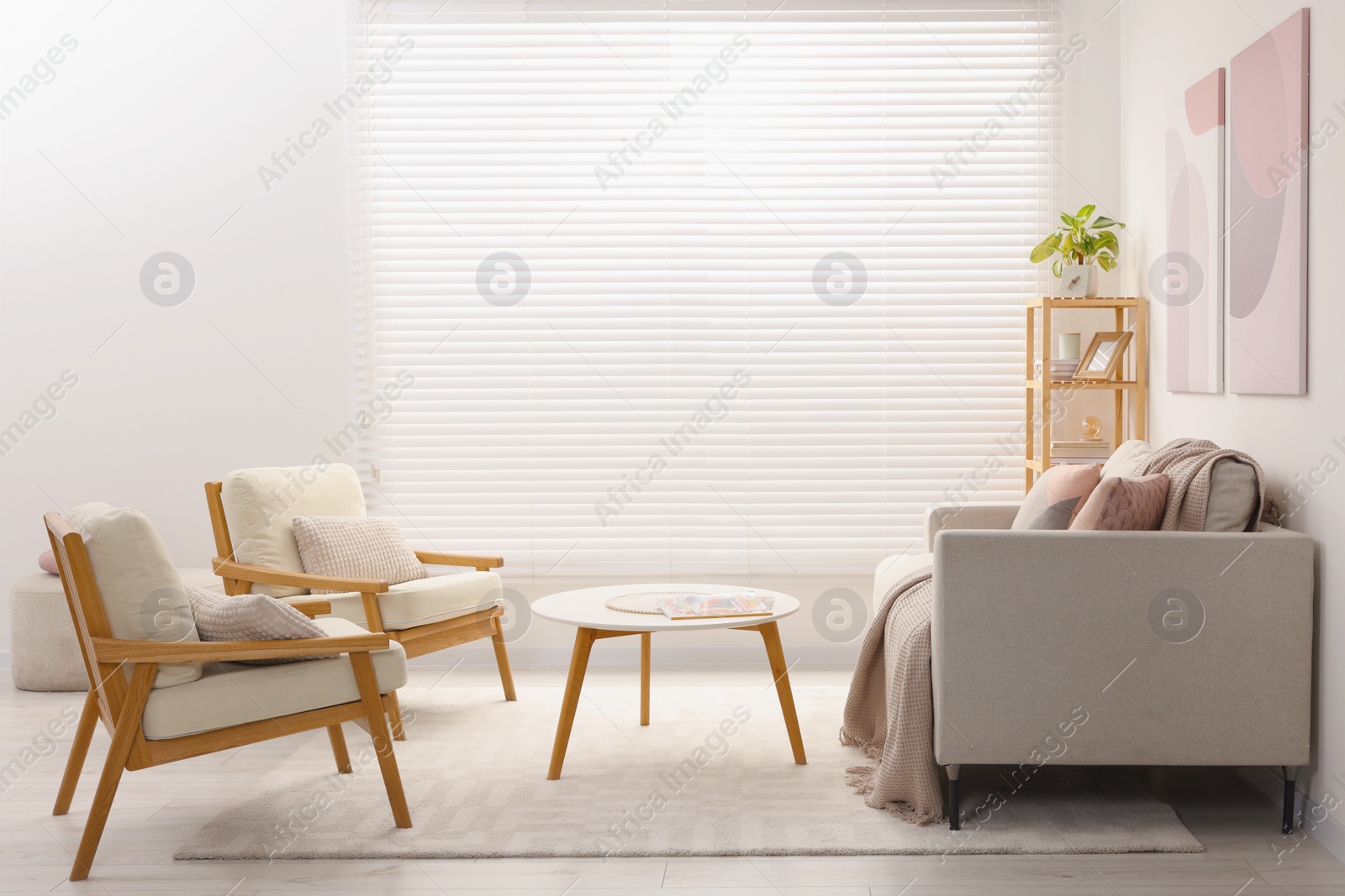 Photo of Stylish living room interior with sofa, coffee table and armchairs