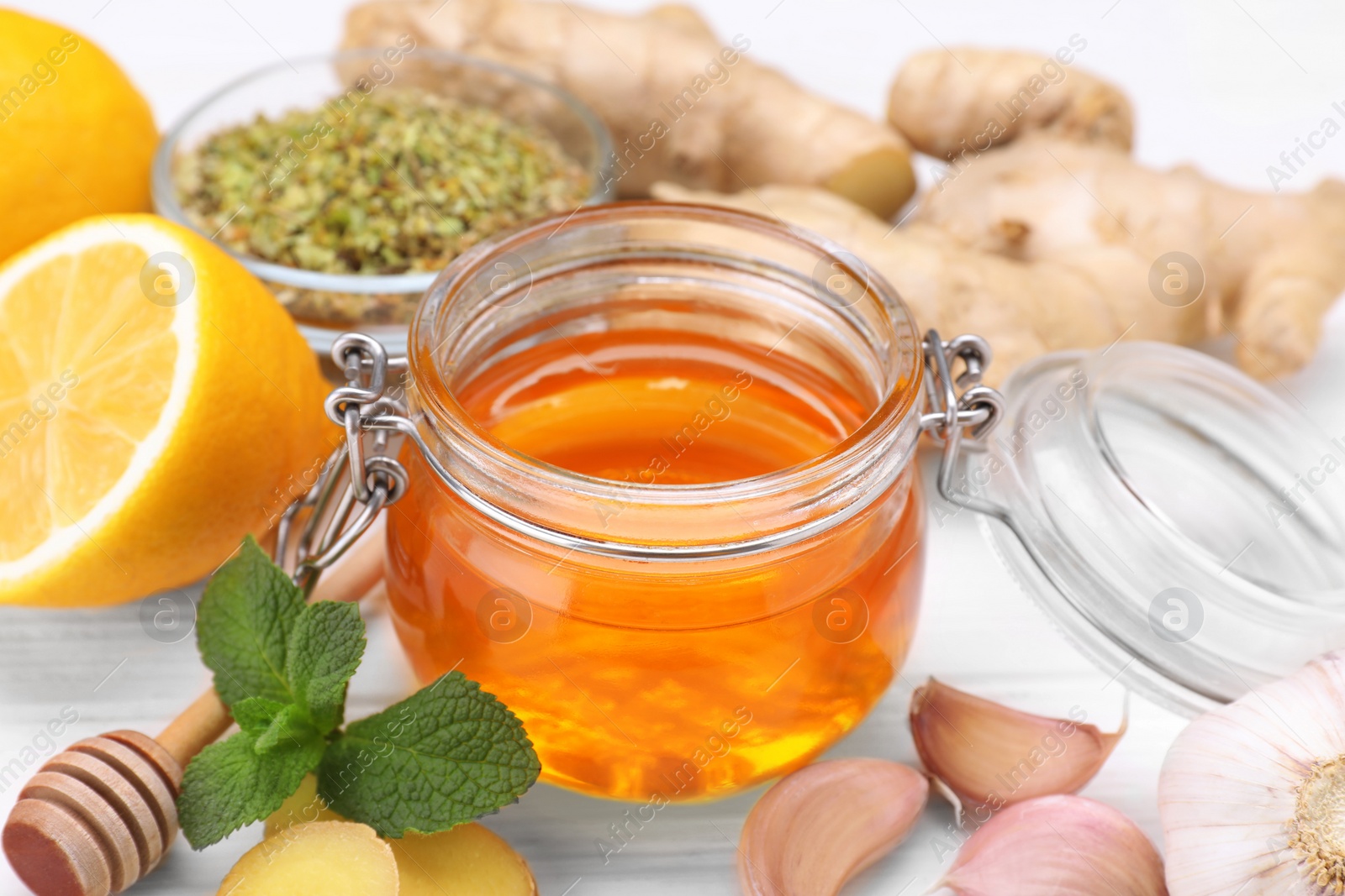 Photo of Different natural cold remedies on white table, closeup. Cough treatment