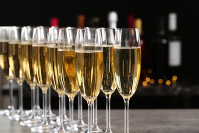 Photo of Many glasses of champagne on blurred background, closeup