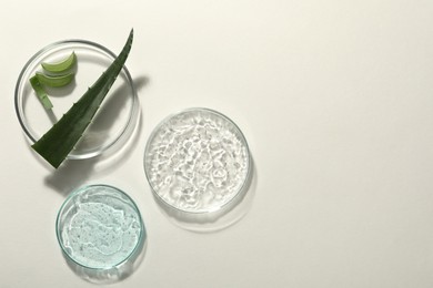 Photo of Flat lay composition with cosmetic gel and aloe on white background, space for text