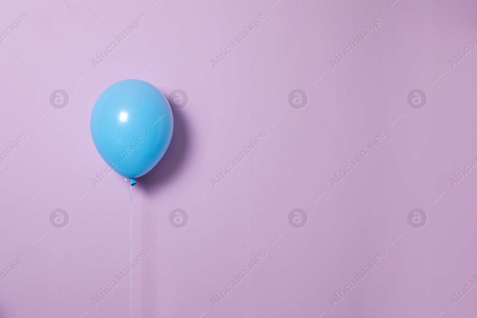 Photo of Blue balloon on color background. Celebration time