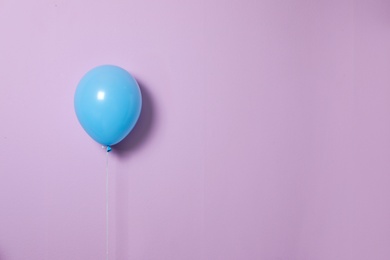 Blue balloon on color background. Celebration time