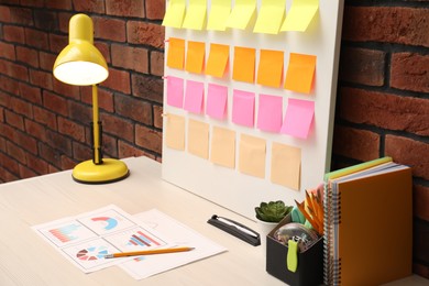 Business process planning and optimization. Workplace with colorful paper notes and other stationery on table