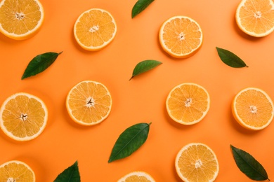 Slices of delicious oranges on color background, flat lay