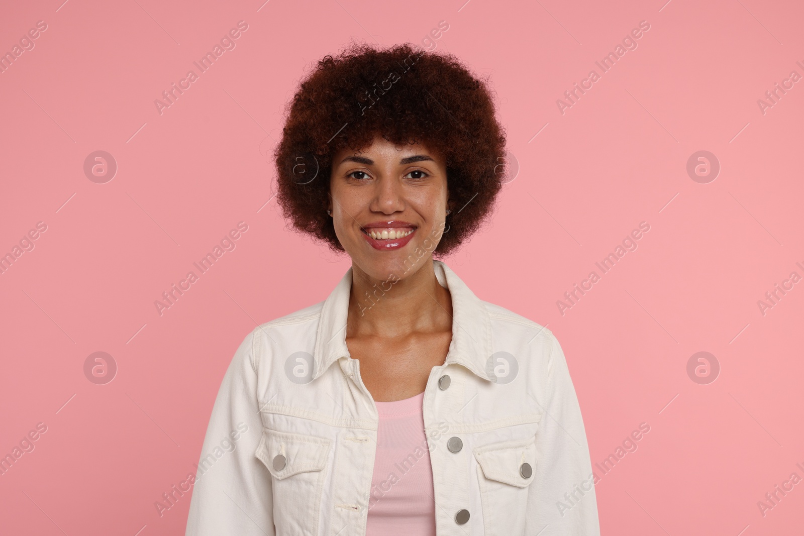 Photo of Portrait of happy young woman on pink background