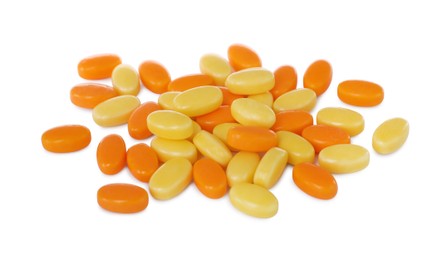 Photo of Tasty yellow and orange dragee candies on white background