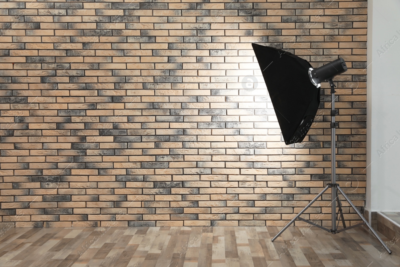 Photo of Professional lighting equipment near wall in photo studio. Space for text