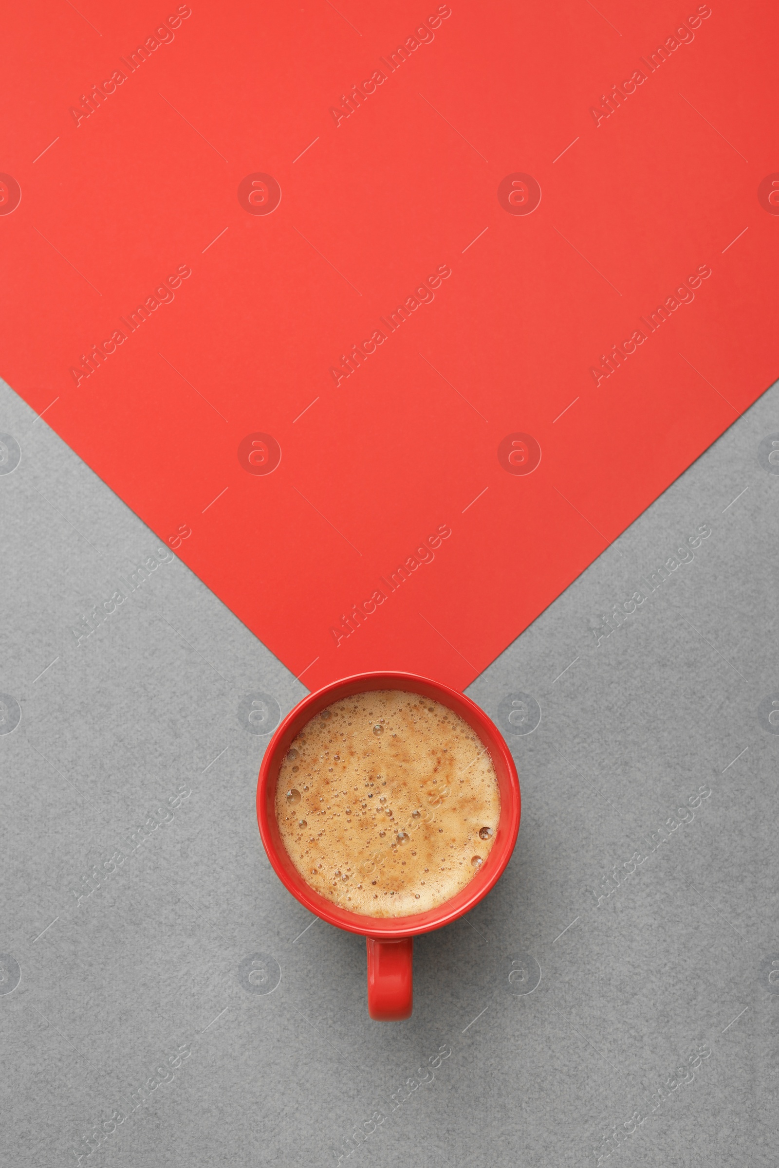 Photo of Cup of coffee on color background, top view. Space for text