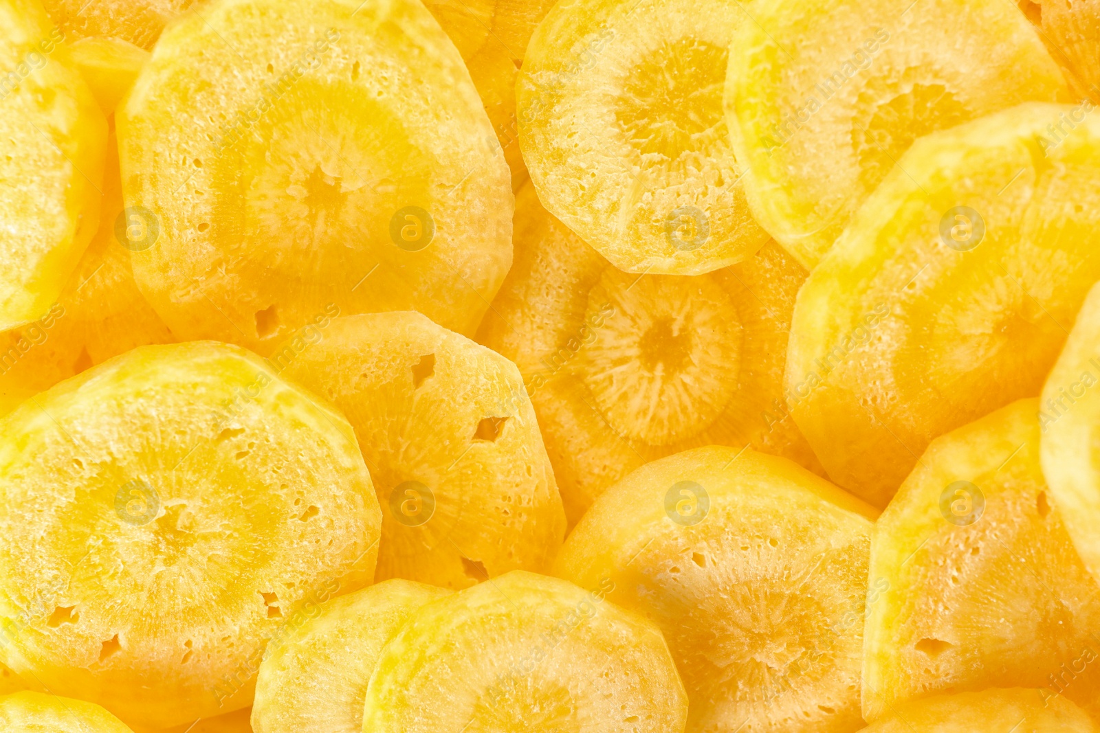 Photo of Slices of raw yellow carrot as background, closeup