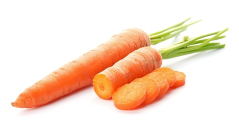 Photo of Whole and cut fresh carrots on white background