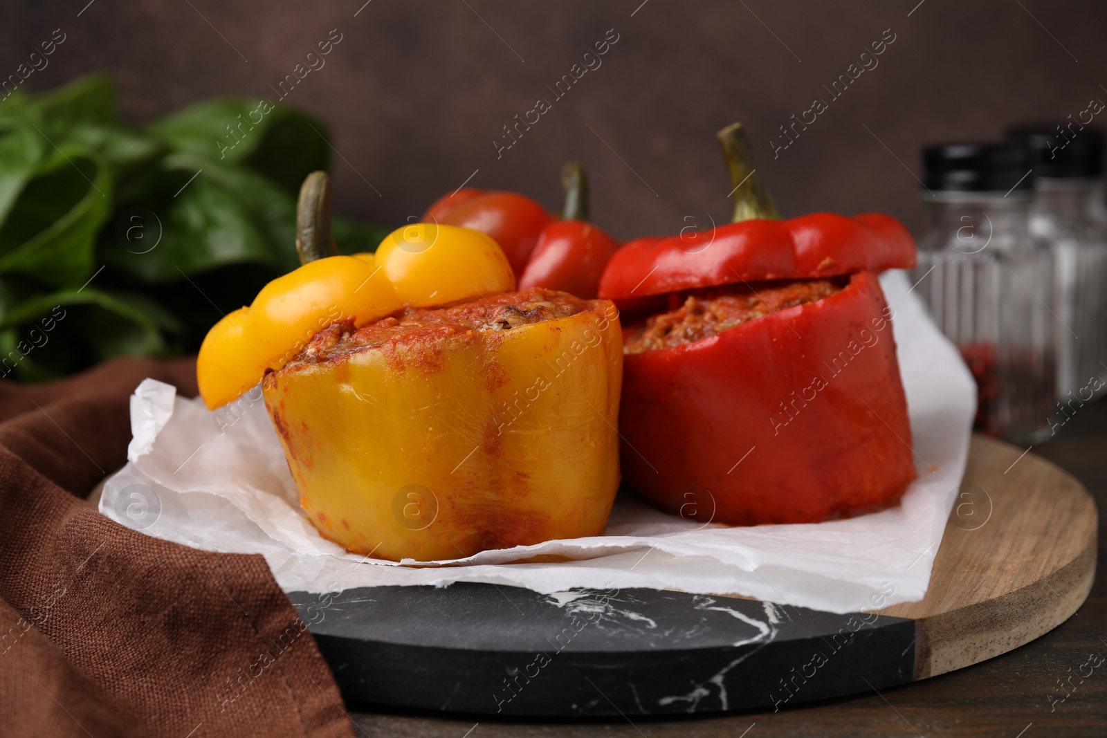 Photo of Delicious stuffed bell peppers served on wooden table, closeup