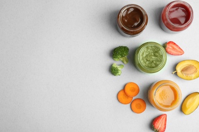 Flat lay composition with healthy baby food and ingredients on grey background. Space for text