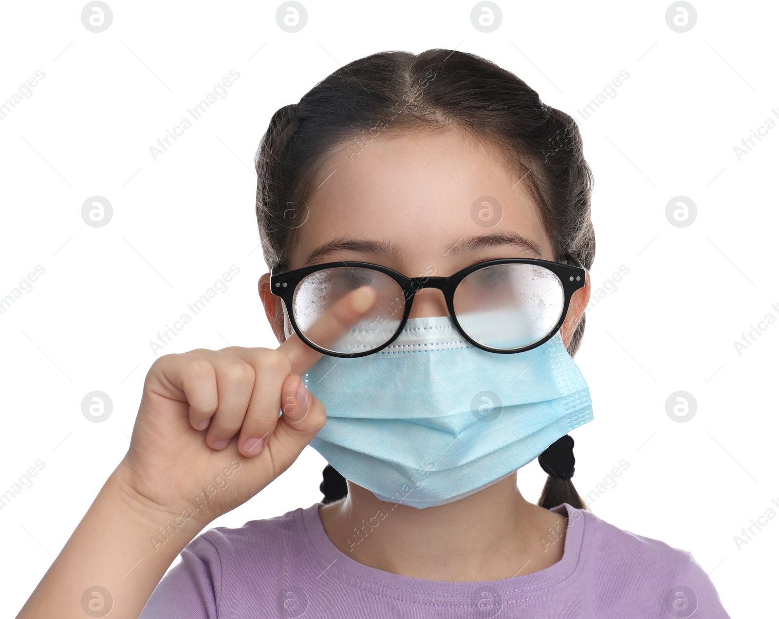 Photo of Little girl wiping foggy glasses caused by wearing medical face mask on white background. Protective measure during coronavirus pandemic